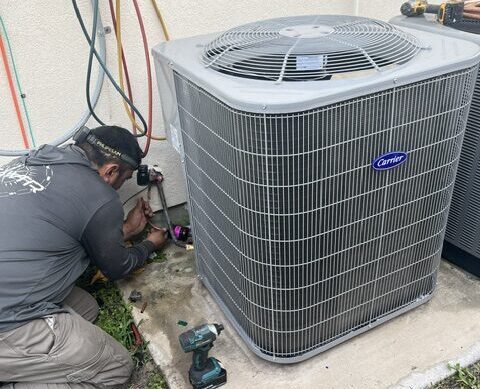 HVAC technician working in front of a McAllen home