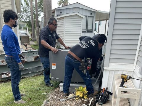 Mission Air Conditioning technicians working on an AC repair in Edinburg, TX.